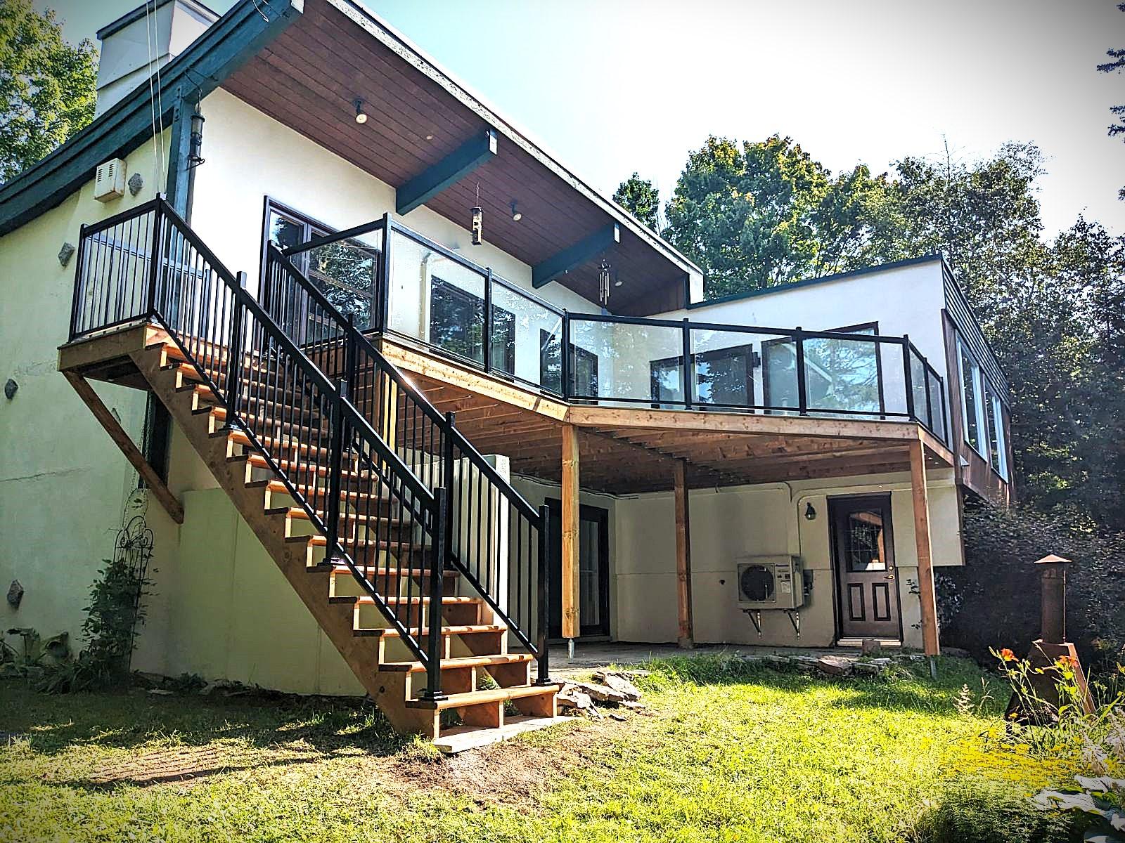Completed wood deck with glass and black railings